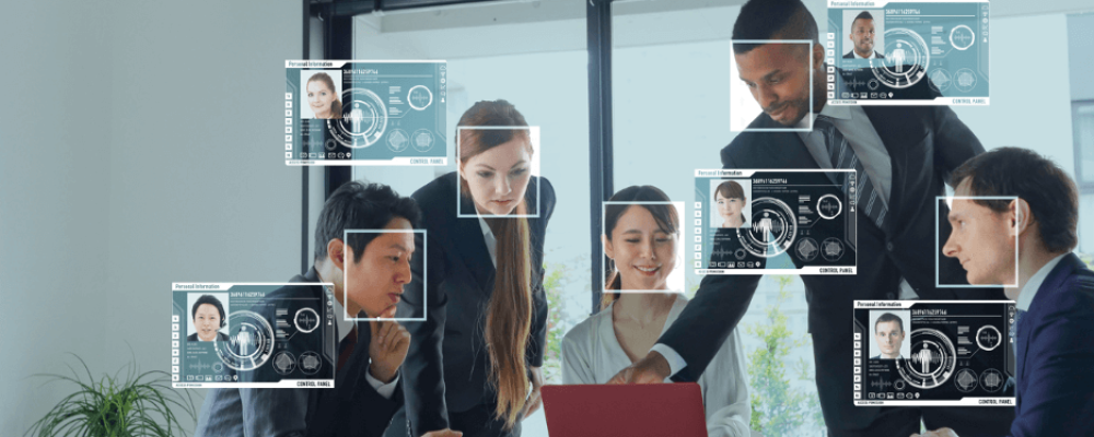 Image of 4 people surrounding a computer and some illustrations representing Attain Insight Intrinsic.